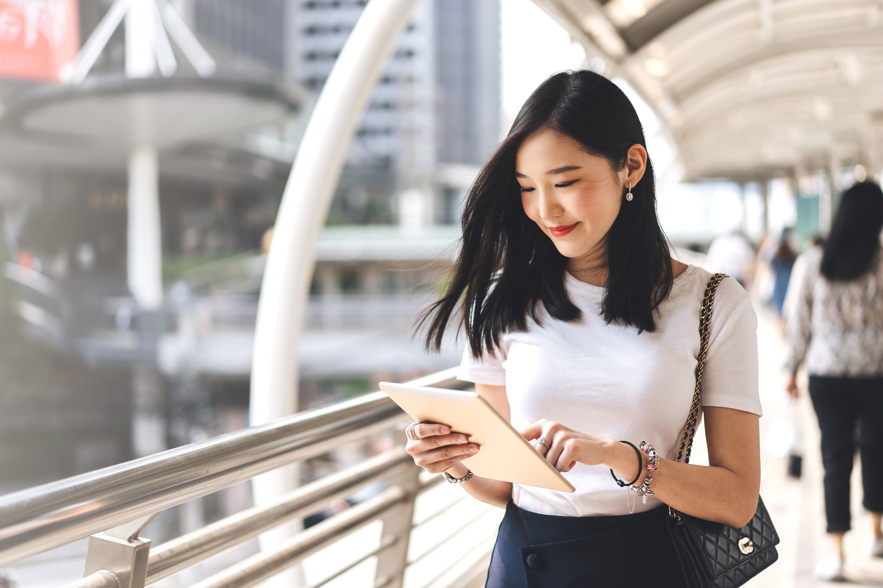 Woman holding tablet smiling