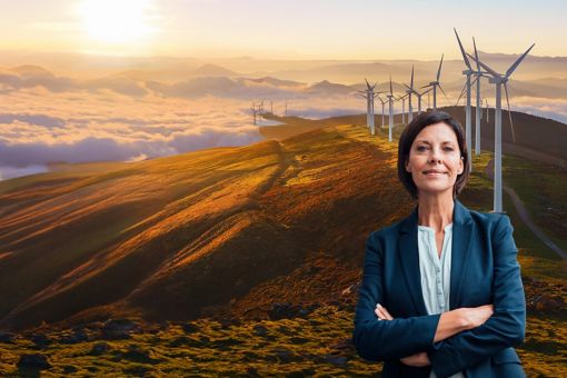 A woman in front of mountains and windmills