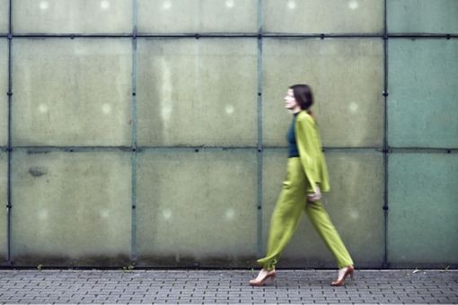 Woman in green formal dress walking