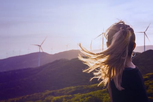 Woman looking at wind turbines