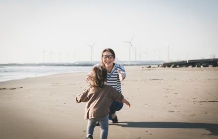 Woman playing with her daughter on beach
