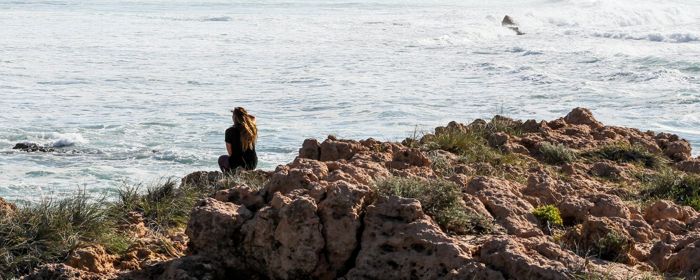 Woman sitting near sea