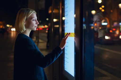 Woman using a large outdoor touch screen