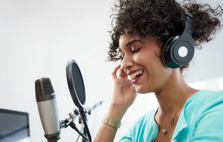 Woman using microphone and headphones