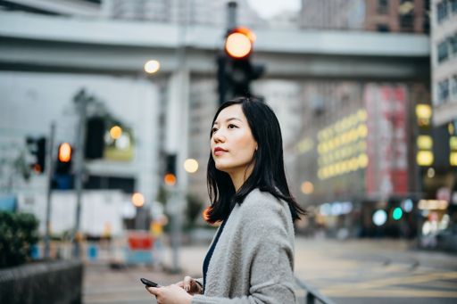 Woman waiting at traffic lights in China