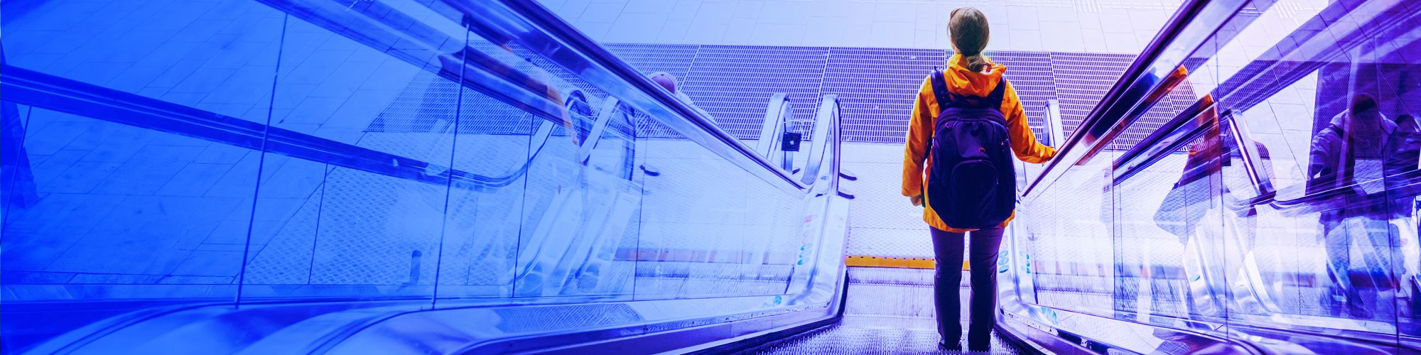 woman with backpack going down on escalator