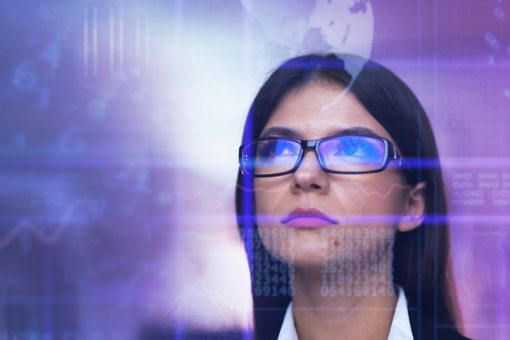 Woman with spectacles looking at screen