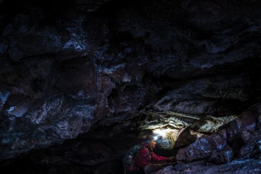 Woman with torch caving