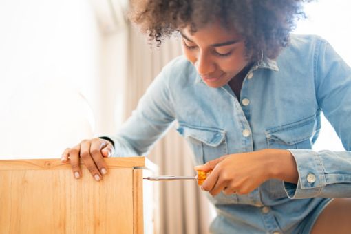 Women using screwdriver.