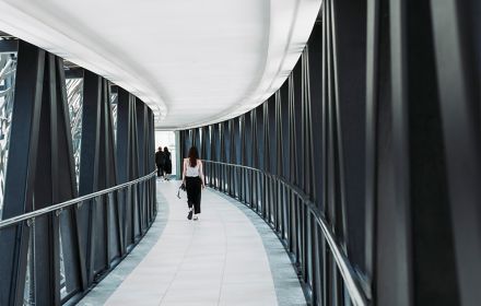 Women walking in corridor with black bars