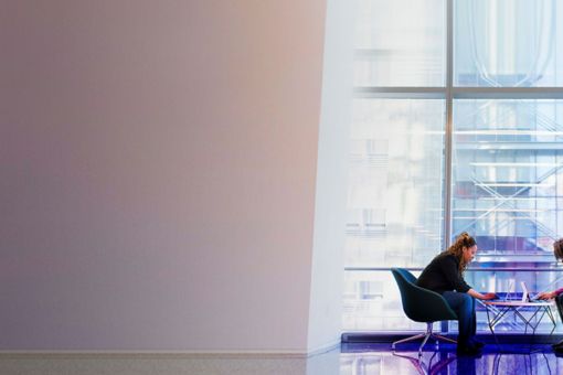 Women working in office sitting on chair