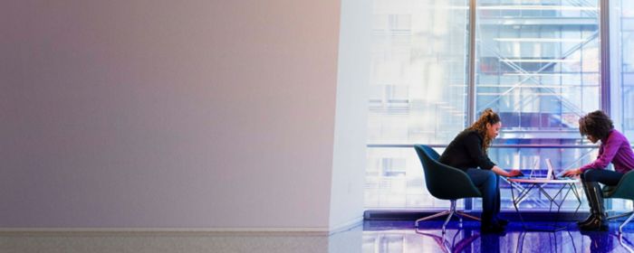 Women working in office sitting on chair