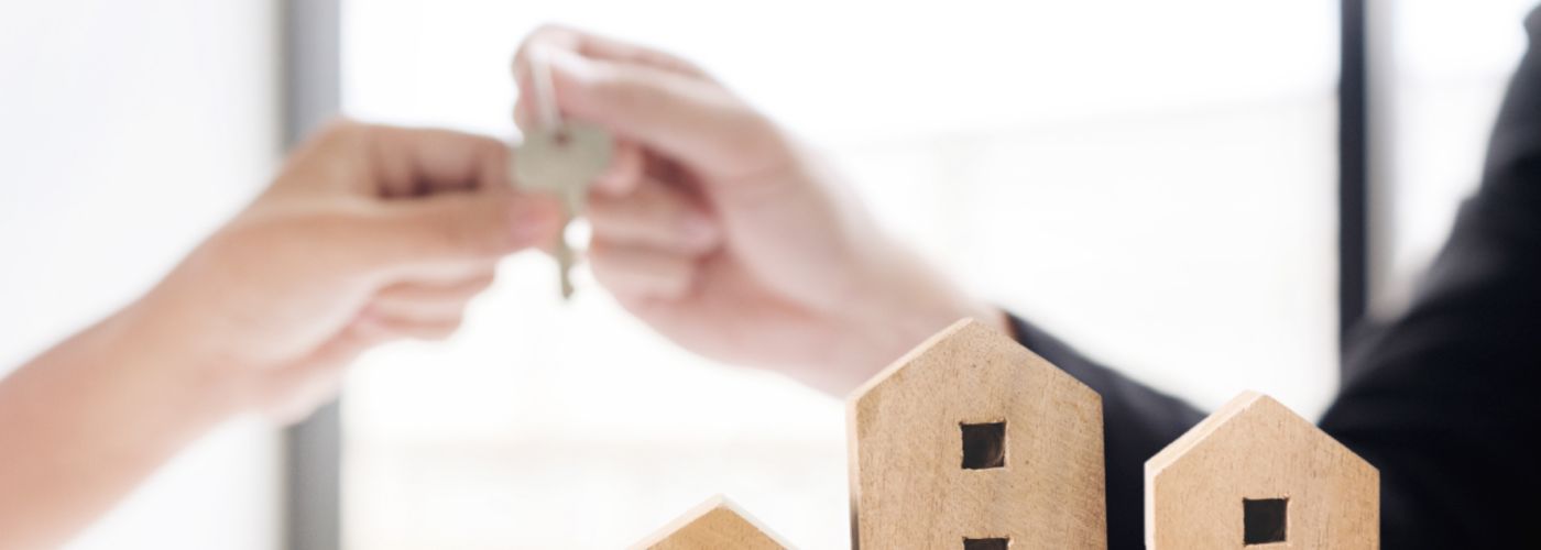 Wooden houses handing key