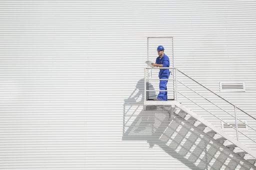 worker with clipboard on the stairs