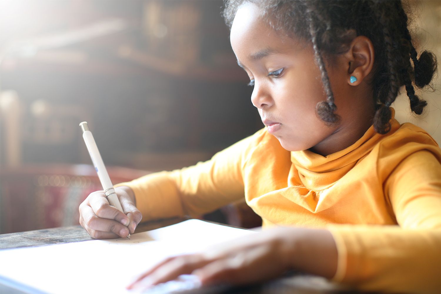 Little girl writing in notebook