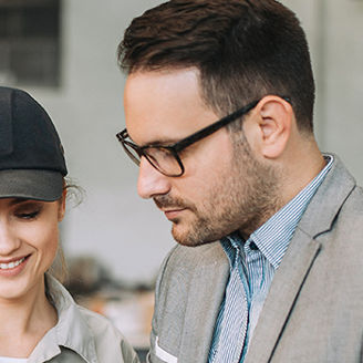 Elegant manager talking with metal industry worker in large workshop.; Shutterstock ID 1770065306; purchase_order: N/A; job: Powered Procurement campaign; client: Janis Cairo; other: 