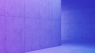 Interior moderno y minimalista de concreto, con grandes losetas cuadradas en piso y paredes, iluminado por luz natural que entra por una abertura rectangular en el techo.