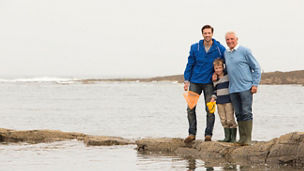 Father, son and Grand Father holding fishing nets.