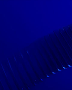 A collection of 3D square transparent shapes in a curved line with a dark blue background