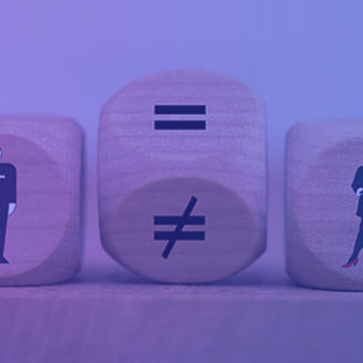 Würfel mit einem Mann und einer Frau, die ein Ungleicheitszeichen auf dir Kippe zum Gleicheitszeichen trennt