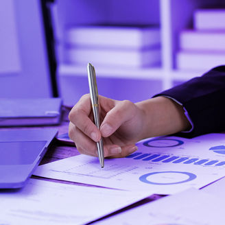 Woman taking notes near her laptop
