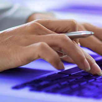 hands typing on keyboard