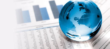Glass globe on financial papers