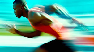Young Black male runner in mid-stride, athletic build, intense focus. Profile view with motion blur, vibrant teal and green tones. Cinematic, high-contrast image capturing speed, energy, and active li