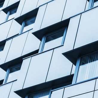 Abstract fragment of modern architecture, walls made steel with shiny windows. Blue tonal filter photo effect