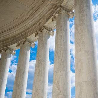 Scenic view of white marble neoclassical columns from the interior of the rotunda at the Jefferson Memorial in Washington DC, USA