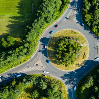Aerial long exposure of traffic on a roundabout in a small town