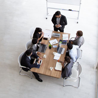 Top view of group of multiethnic busy people working in an office, Aerial view with businessman and businesswoman sitting around a conference table with blank copy space, Business meeting concept