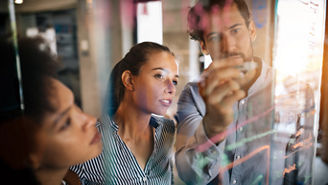 Programmers working cooperating at IT company developing apps