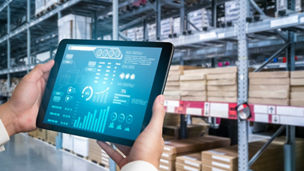 Warehouse management innovative software in computer for real time monitoring of goods package delivery . Computer screen showing smart inventory dashboard for storage and supply chain distribution .