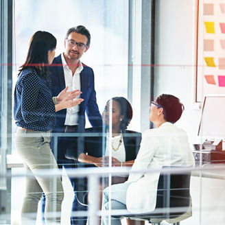 Full length shot of four business colleagues working in the office.