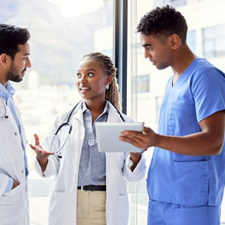 Shot of a group of doctors using a digital tablet at work.