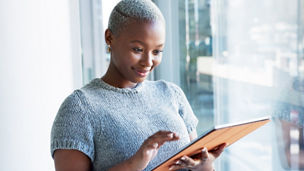 Business woman and office research on tablet for positive insight with wireless wifi gadget. Satisfied black person in corporate career typing important data on digital device with internet