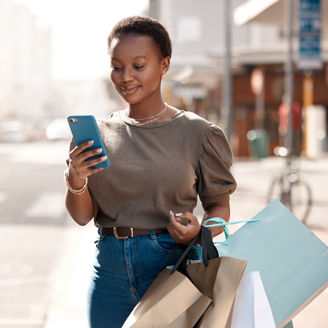 Shopping, bag and phone with black woman in city for social media, networking and communication. Fashion, retail and luxury with female customer in Nigeria Town for contact, ecommerce app and sale.