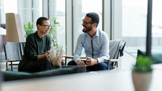 Business people having meeting in office lobby