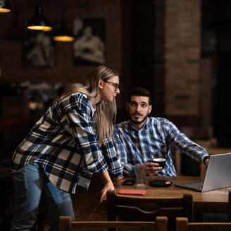 Two young people, husband and wife, Pub owners, working in their cafeteria, cleaning and calculating before opening time. Man and woman work in coffee shop, ordering drinks from delivery company