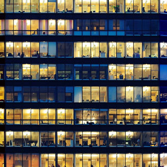 Workers working late. Blue hour. Curved building