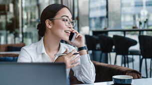 Asian business woman making a phone call and smiling indoor