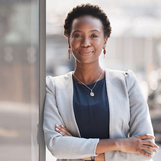 A black woman wearing a suit smiles
