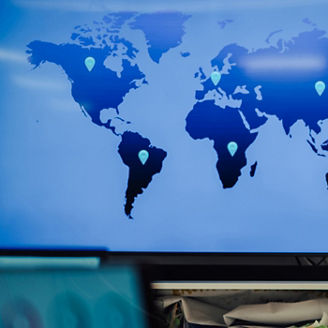 A woman stands next to world map