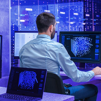 A man is working by using a multiple computer