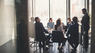 Businessman presenting to table of business people