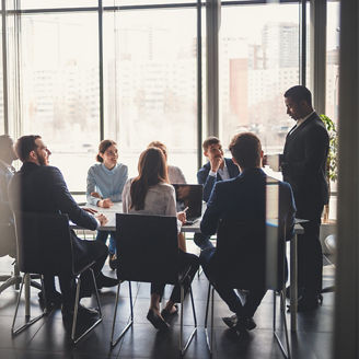 Businessman presenting to table of business people