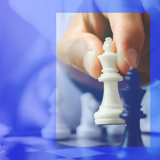 Man placing white chess piece