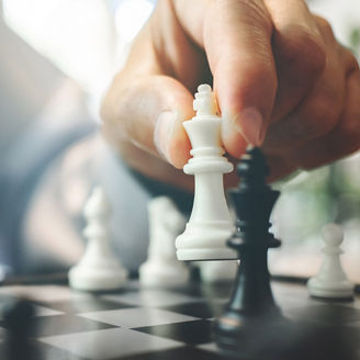 Man placing white chess piece