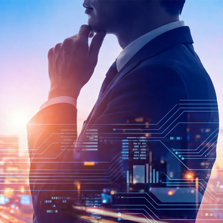Side profile of a man in a suit with a hand resting on the chin, overlaid with digital interface graphics against a blurred city skyline and illuminated roadway at dusk